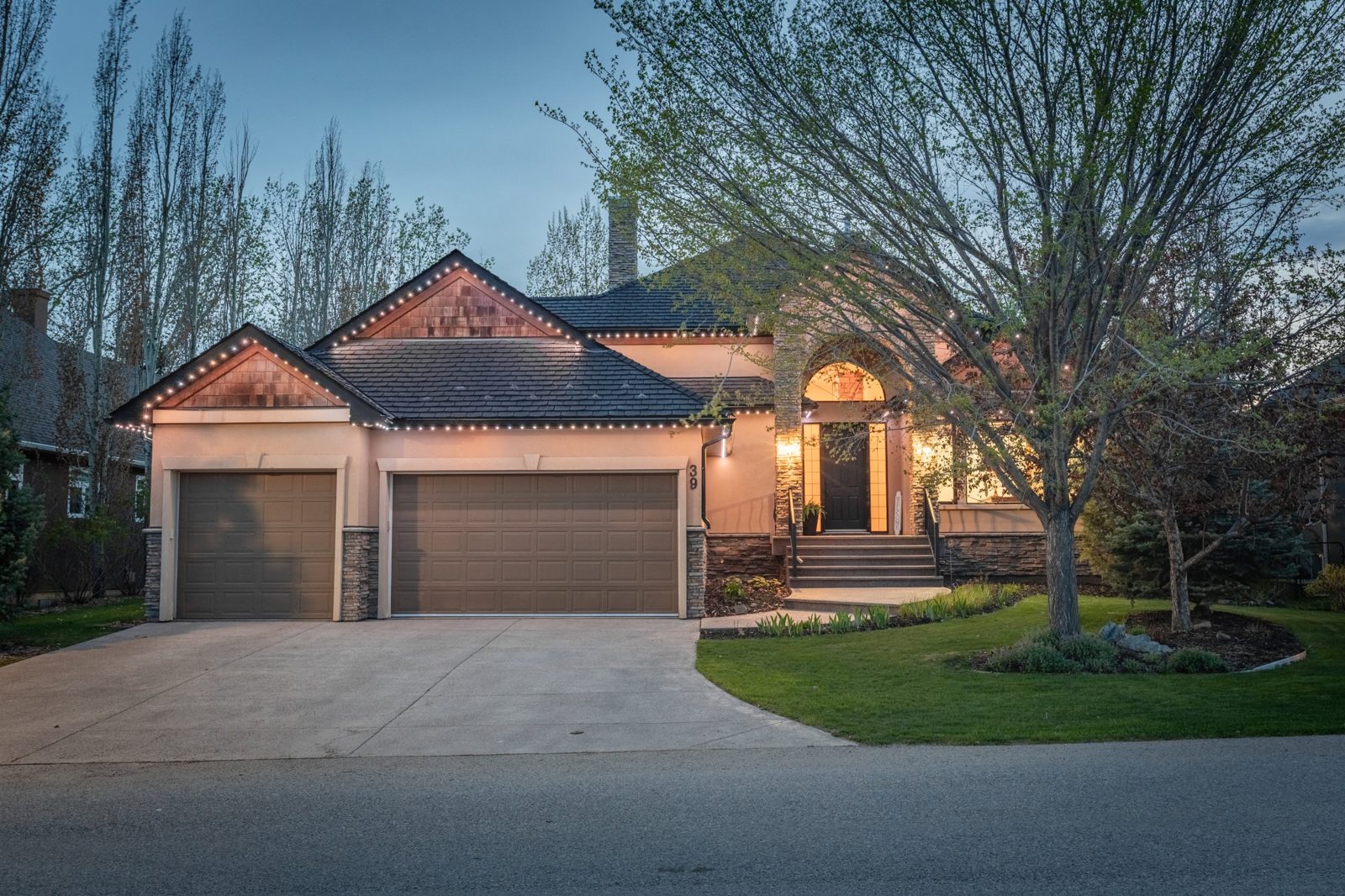Executive estate home at dusk in the Foothills marketed by TJ Hart-Anderson, REMAX REALTOR®