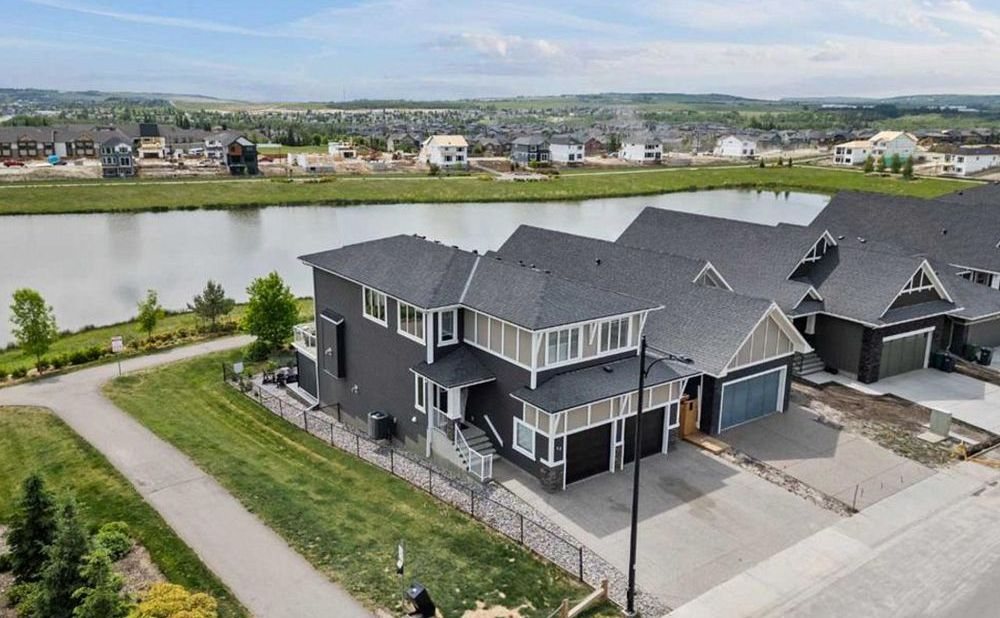 New construction homes backing onto a pond in D'Arcy, north Okotoks, sold by TJ Hart-Anderson