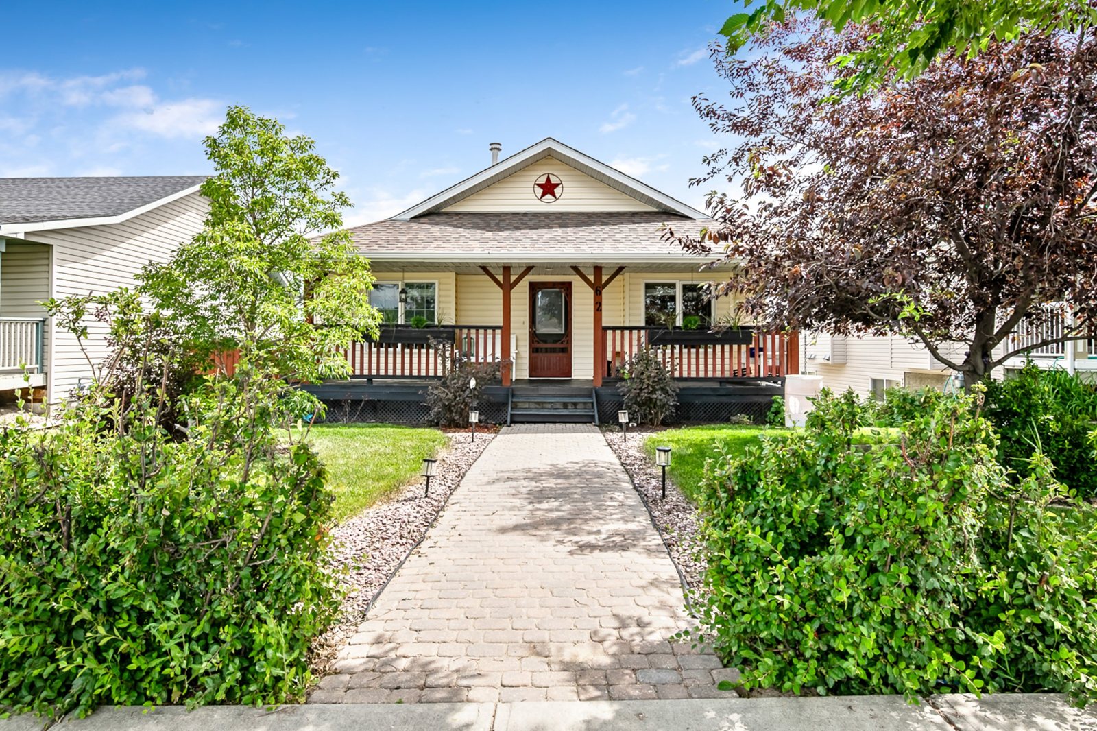 Bungalow with a covered front porch in Westmount, Okotoks, listed by TJ Hart-Anderson